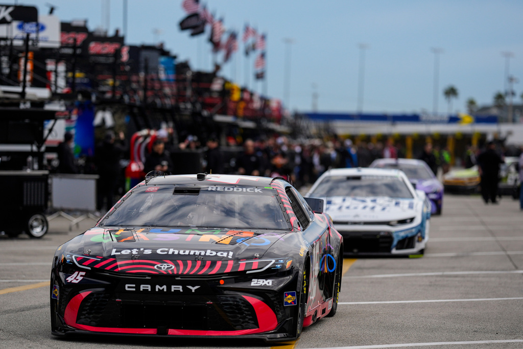 Driver Tyler Reddick leads other cars out to the track during a NASCAR Daytona 500 practice, Wednesday, Feb. 11, 2026, in Daytona, Fla. (AP Photo/Mike Stewart)
