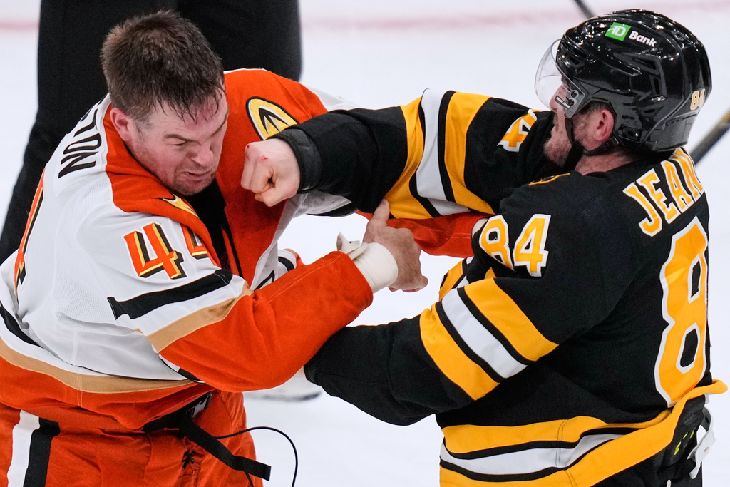 Boston Bruins left wing Tanner Jeannot (84) lands a punch in a fight against Anaheim Ducks left wing Ross Johnston (44) during the second period of an NHL hockey game, Thursday, Oct. 23, 2025, in Boston. (AP Photo/Charles Krupa)
