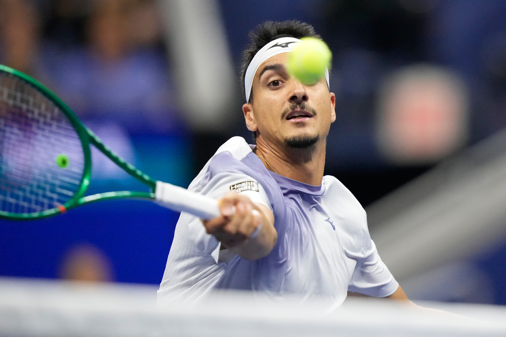 Lorenzo Sonego, of Italy, hits a return to Alexander Zverev, of Germany, in the fourth set during the first round of the U.S. Open tennis championships early Wednesday, Sept. 2, 2026, in New York. (AP Photo/Frank Franklin II)