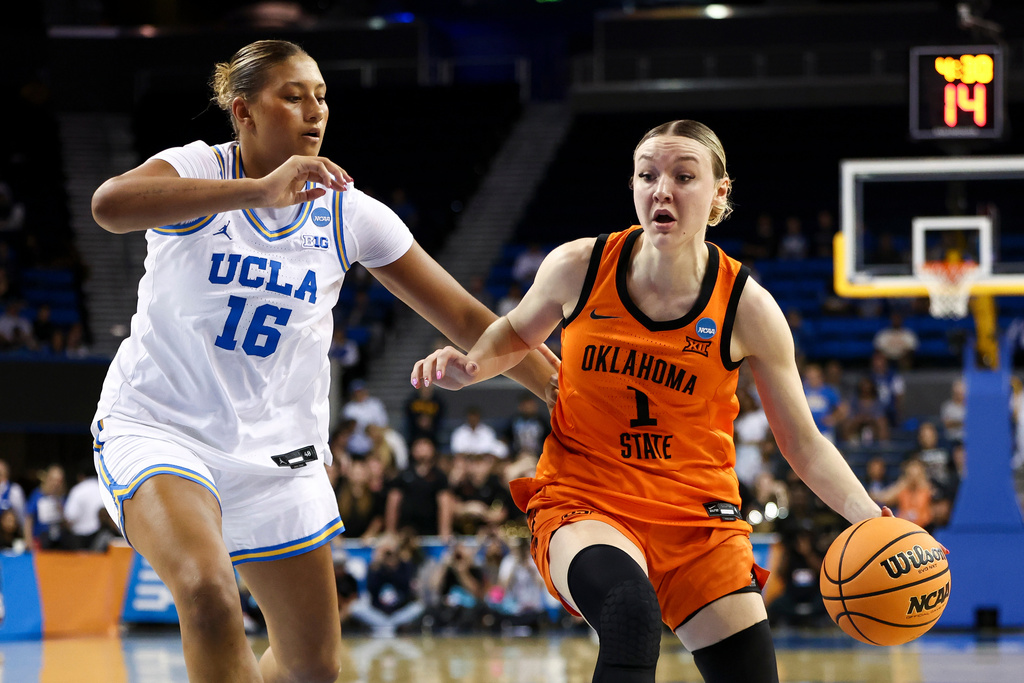Oklahoma State guard Amari Whiting (1) drives against UCLA forward Sienna Betts (16) during the first half in the second round of the NCAA college basketball tournament, Monday, March 23, 2026, in Los Angeles. (AP Photo/Jessie Alcheh)