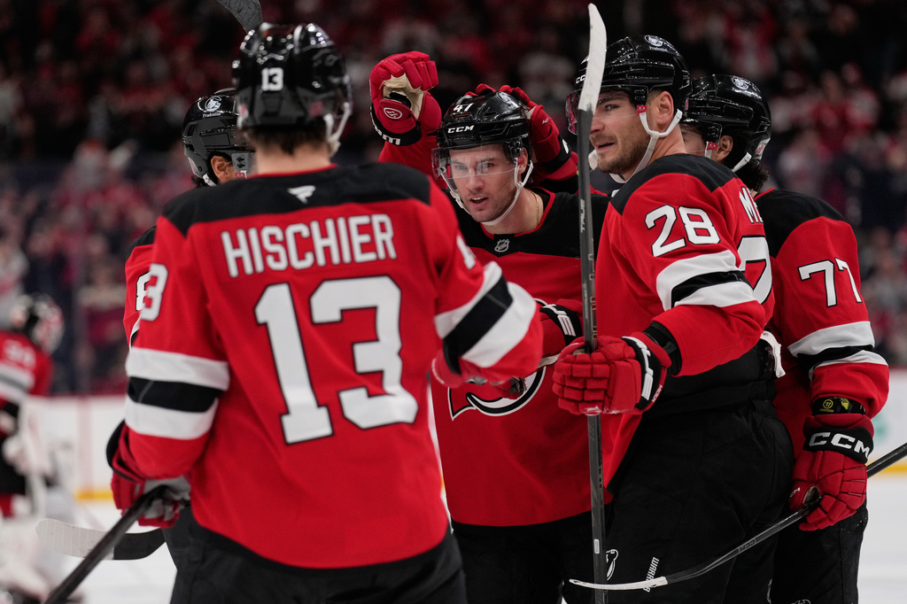 New Jersey Devils' Declan Chisholm, center, celebrates his goal with teammates during the second period of an NHL hockey game against the Colorado Avalanche in Newark, N.J., Tuesday, Oct. 20, 2026. (AP Photo/Seth Wenig)