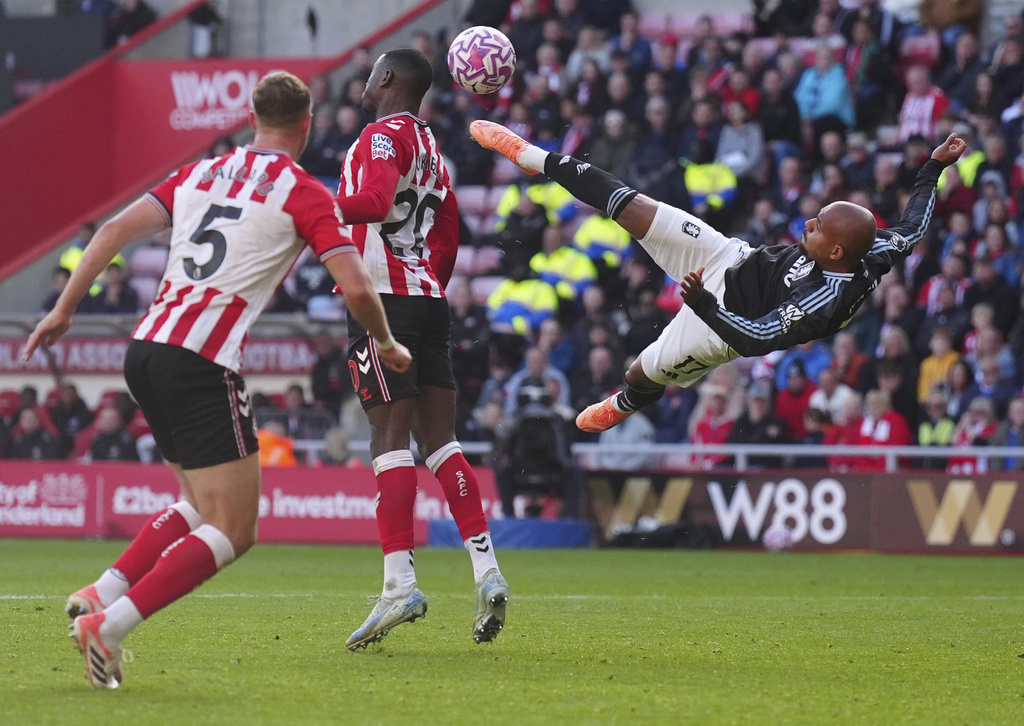 Aston Villa's Donyell Malen, right, in action during the English Premier League soccer match between Sunderland and Aston Villa at the Stadium of Light, in Sunderland, England, Sunday Sept. 21, 2025. (Owen Humphreys/PA via AP)