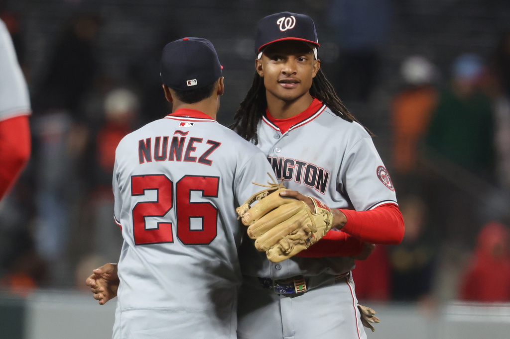 Washington Nationals shortstop CJ Abrams, right, and Nasim Nuñez (26) celebrate their team's victory over the San Francisco Giants at a baseball game in San Francisco, Tuesday, June 9, 2026. (AP Photo/Jed Jacobsohn)