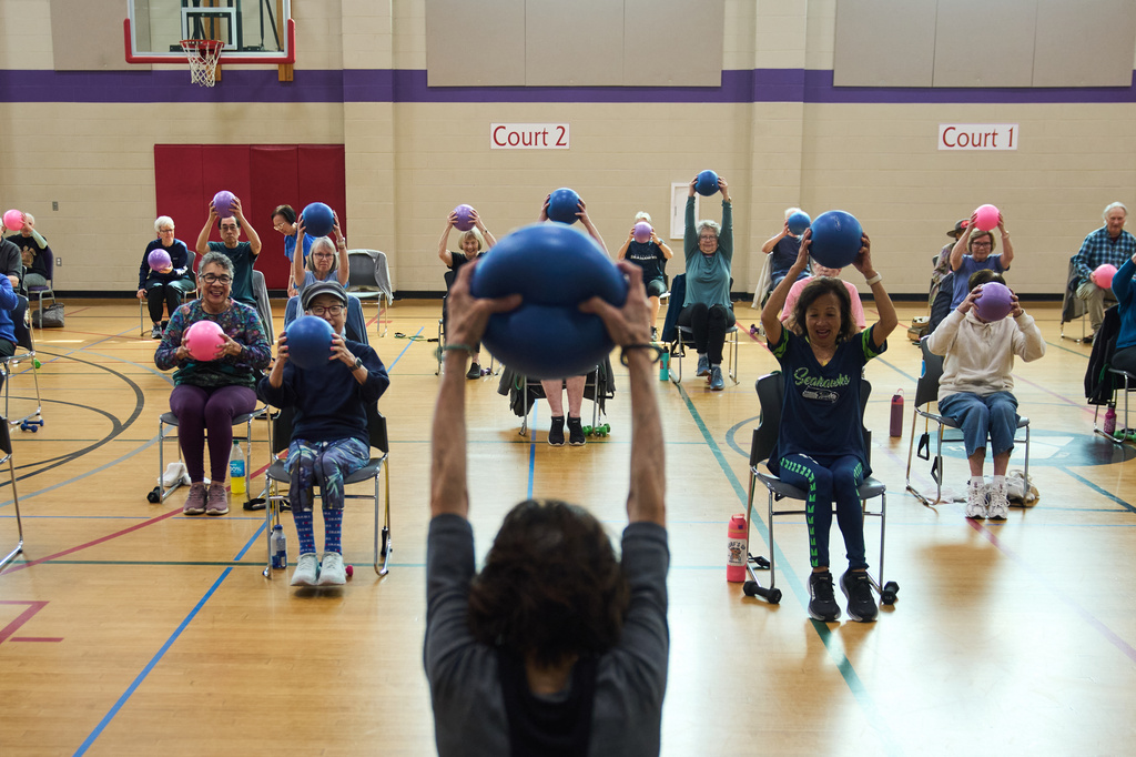 Instructor Bengie Santos, 72, foreground center, leads a class for older adults at the Dale Turner Family YMCA, April 30, 2026, in Shoreline, Wash. (AP Photo/Lindsey Wasson)