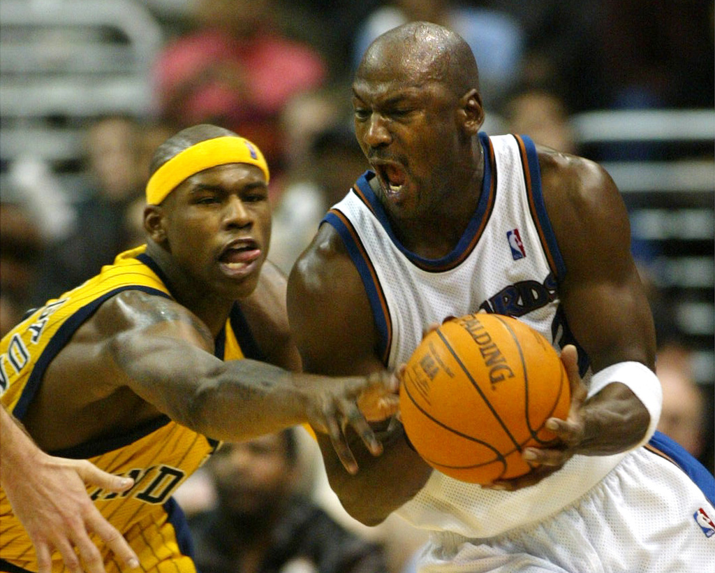 FILE - Washington Wizards' Michael Jordan gets control of the ball with pressure from Indiana Pacers' Al Harrington in the fourth quarter of play, Jan. 4, 2003, in Washington. (AP PHoto/Lawrence Jackson, File)