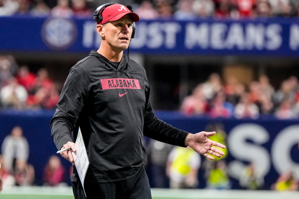 Alabama head coach Kalen Deboer speaks to an official during the first half of a Southeastern Conference championship NCAA college football game between Georgia and Alabama, Saturday, Dec. 6, 2025, in Atlanta. (AP Photo/Mike Stewart)