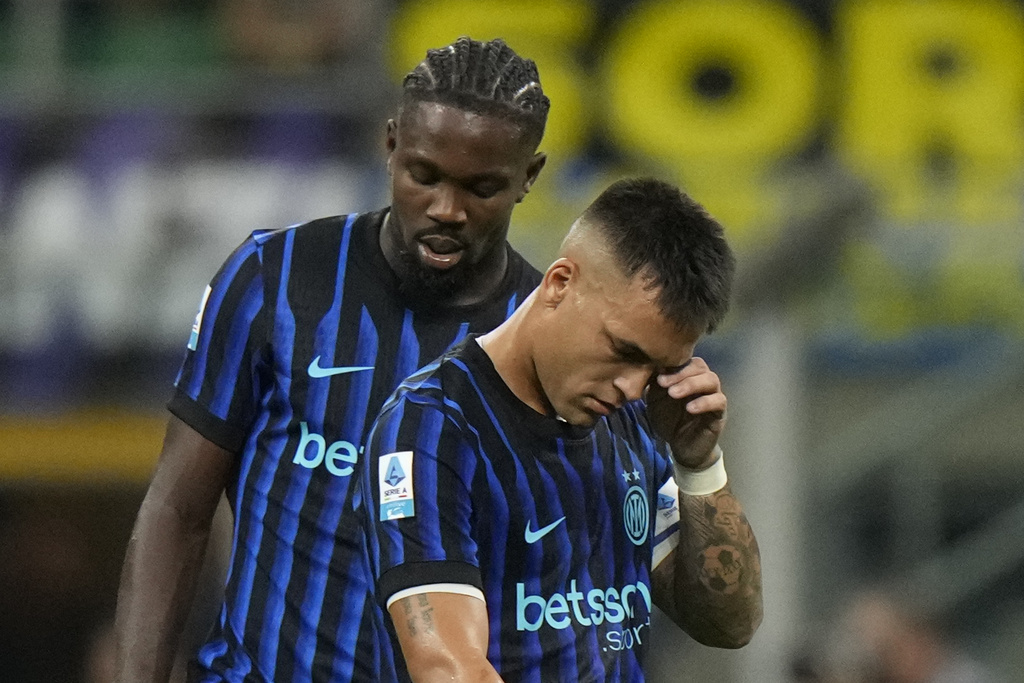 Inter Milan's Lautaro Martinez and his teammate Marcus Thuram react after Udinese's Arthur Atta scored his side's second goal during a Serie A soccer match between Inter Milan and Udinese at the San Siro stadium in Milan, Italy, Sunday, Aug.31, 2025. (AP Photo/Luca Bruno)
