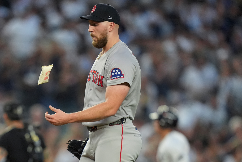 Boston Red Sox pitcher Garrett Crochet reacts after giving up a solo home run to New York Yankees' Anthony Volpe during the second inning of Game 1 of an American League wild-card baseball playoff series, Tuesday, Sept. 30, 2025, in New York. (AP Photo/Frank Franklin II)