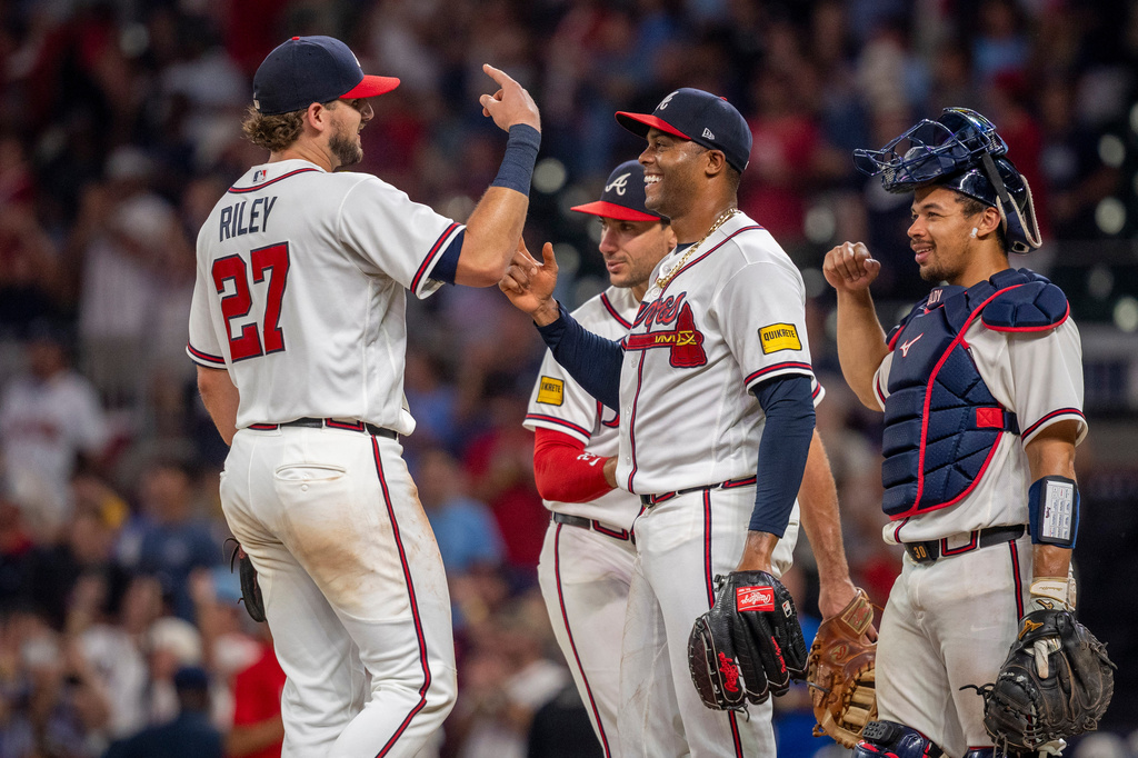 Atlanta Braves Raisel Iglesias (26), right, is congradulated by teammate Austin Riley (27), left, at the end of a baseball game against the St. Louis Cardinals Wednesday, July 1, 2026, in Atlanta. (AP Photo/Erik Rank)