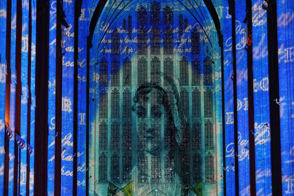 FILE - A sound and light show with a literary theme developed by Luxmuralis, which includes a section on writer Jane Austen, is screened inside Winchester Cathedral in Winchester, England, Tuesday, March 11, 2025. (AP Photo/Alastair Grant, file)