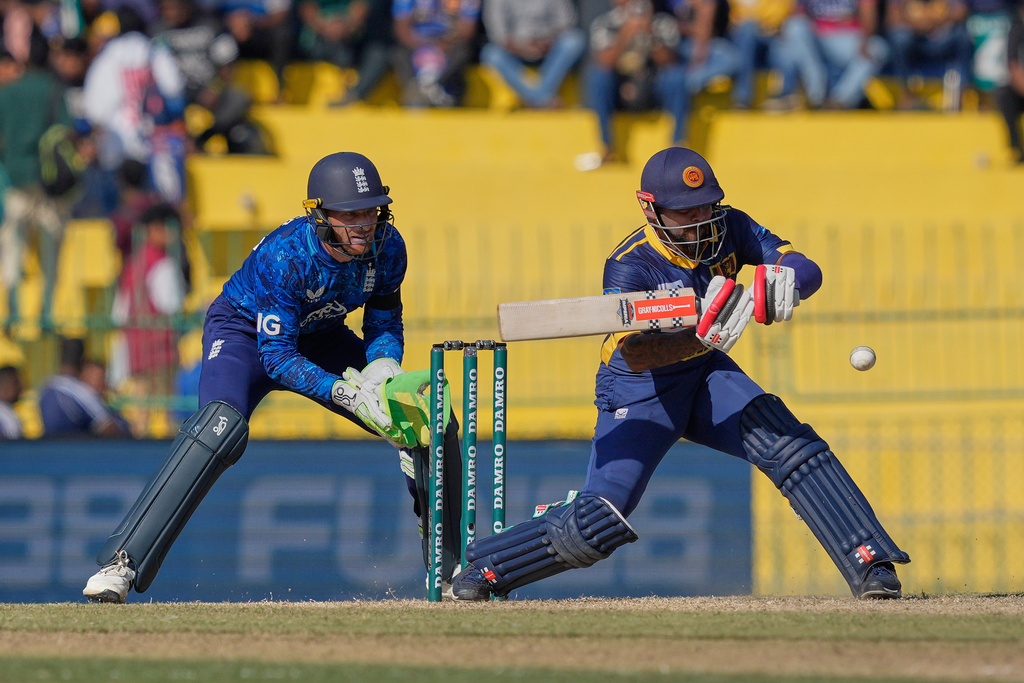 Sri Lanka's Kusal Mendis plays a shot as England's Jos Butler watches during the first ODI cricket match between England and Sri Lanka in Colombo, Sri Lanka, Thursday, Jan. 22, 2026. (AP Photo/Eranga Jayawardena)