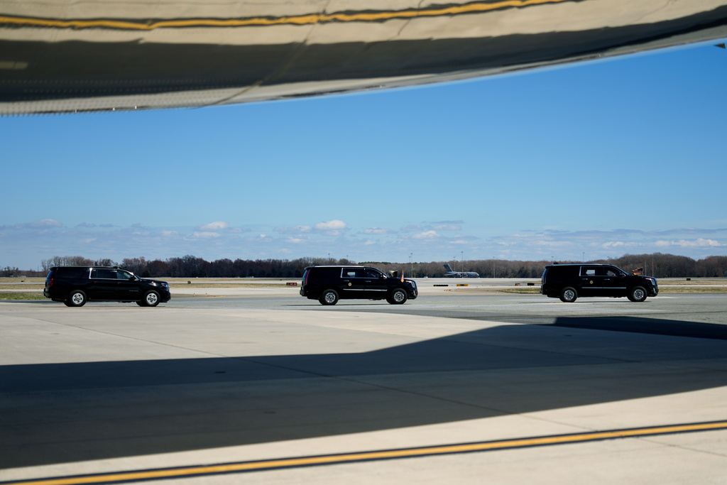 A motorcade drives President Donald Trump past Air Force One, Wednesday, March 18, 2026, at Dover Air Force Base, Del., to attend the casualty return for the six crew members of an Air Force refueling aircraft who died when their plane crashed in western Iraq while supporting operations against Iran. (AP Photo/Julia Demaree Nikhinson)