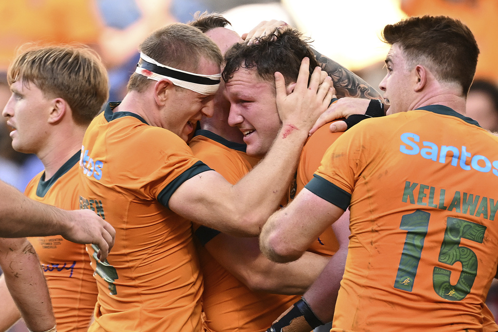Angus Bell, center, of the Wallabies is congratulated by teammates after scoring the match winning try during the rugby international between Australia and Argentina in Townsville, Australia, Saturday, Sept. 6, 2025. (Dave Hunt/AAP Image via AP)