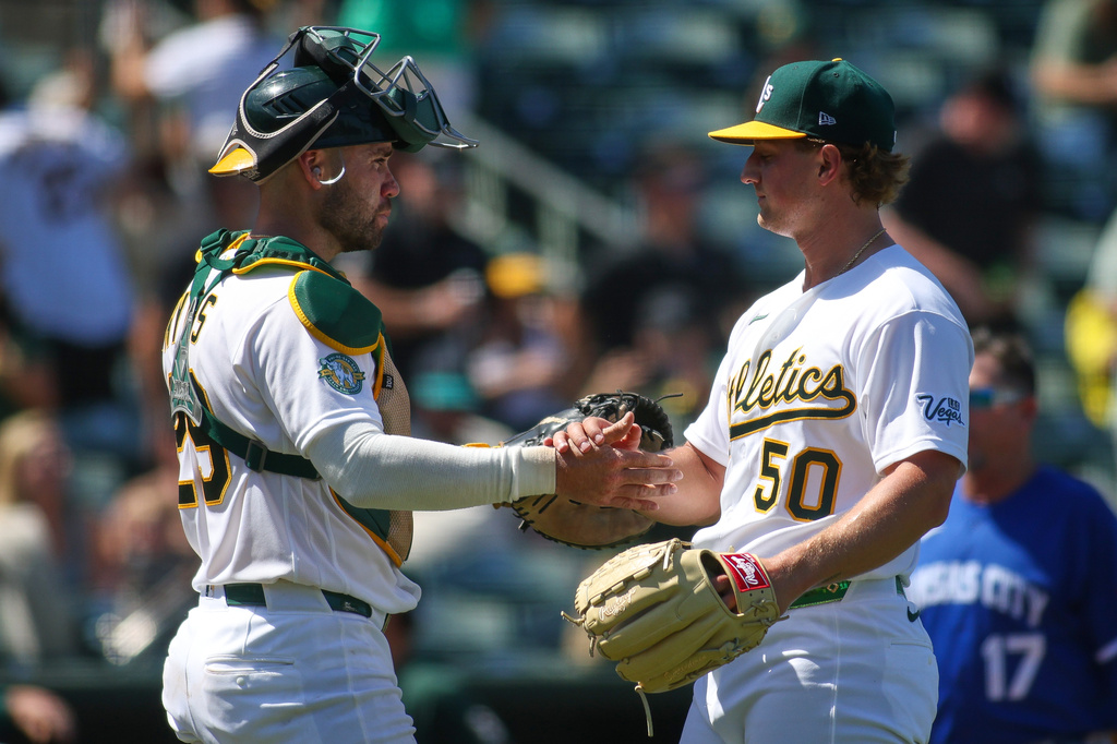 Athletics pitcher Jack Perkins (50) celebrates with catcher Austin Wynns, left, after the final out of the ninth inning of a baseball game as the Athletics defeat the Kansas City Royals Thursday, April 30, 2026, in West Sacramento, Calif. (AP Photo/Scott Marshall)