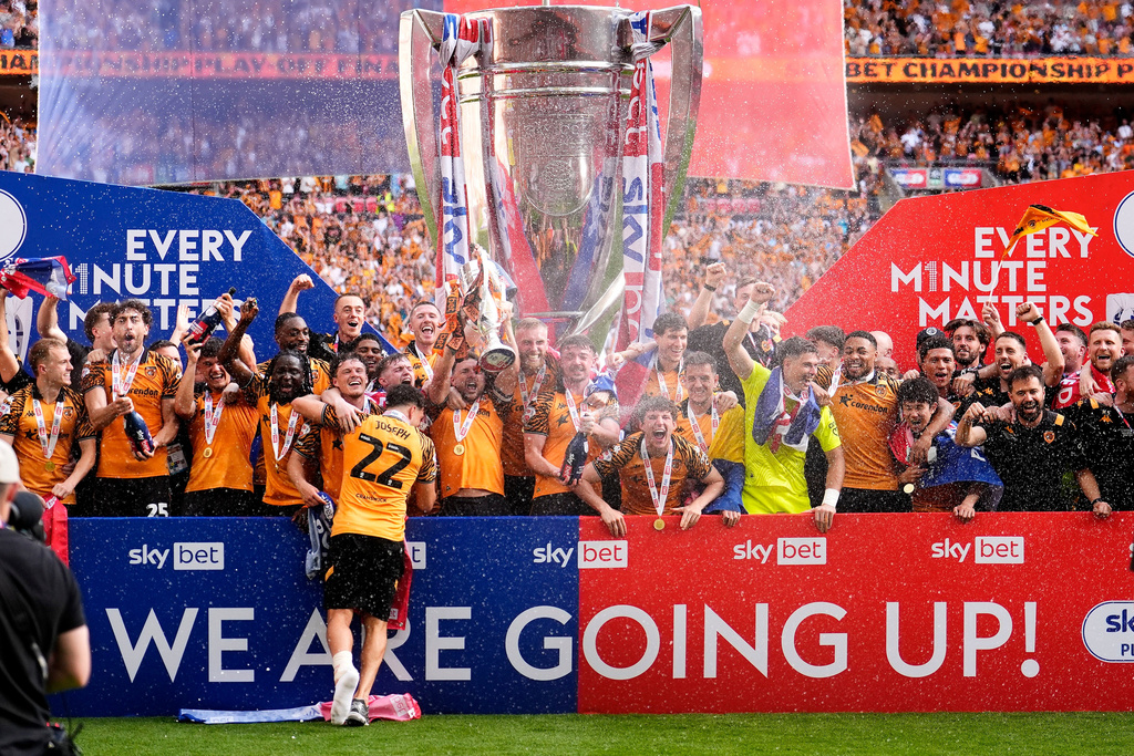 Hull City players celebrate winning promotion to the Premier League following the Championship play-off final between Hull City and Middlesbrough at Wembley Stadium, London, Saturday May 23, 2026. (Jordan Pettitt/PA via AP)