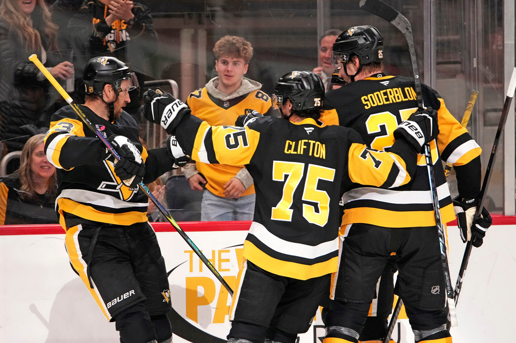 Pittsburgh Penguins' Kevin Hayes, left, celebrates his goal during the second period of an NHL hockey game against the Washington Capitals in Pittsburgh, Saturday, April 11, 2026. (AP Photo/Gene J. Puskar)