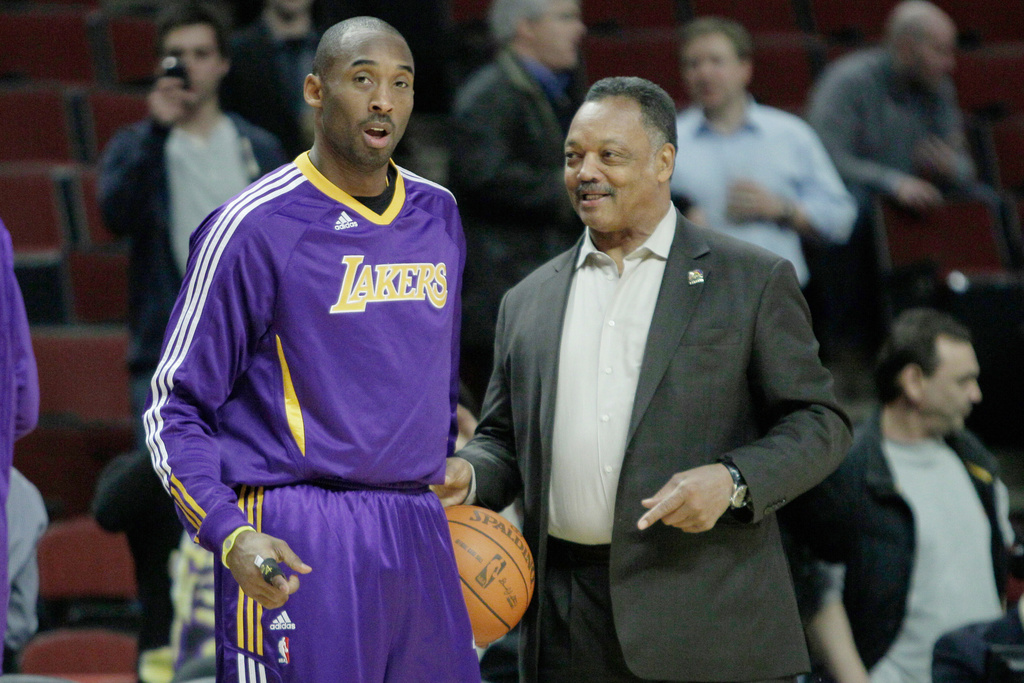FILE - The Rev. Jesse Jackson, right, talks to Los Angeles Lakers' Kobe Bryant during warmups before an NBA basketball game against the Chicago Bulls in Chicago, Friday, Dec. 10, 2010. (AP Photo/Nam Y. Huh, File)
