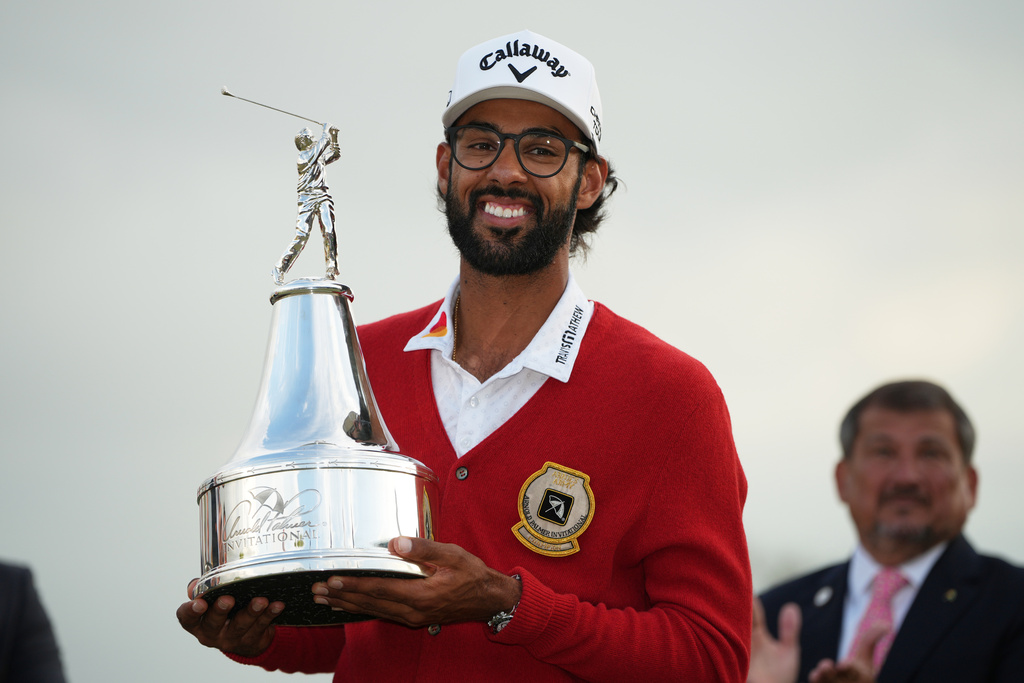 Akshay Bhatia holds the championship trophy after winning the Arnold Palmer Invitational at Bay Hill golf tournament Sunday, March 8, 2026, in Orlando, Fla. (AP Photo/Matt Slocum)