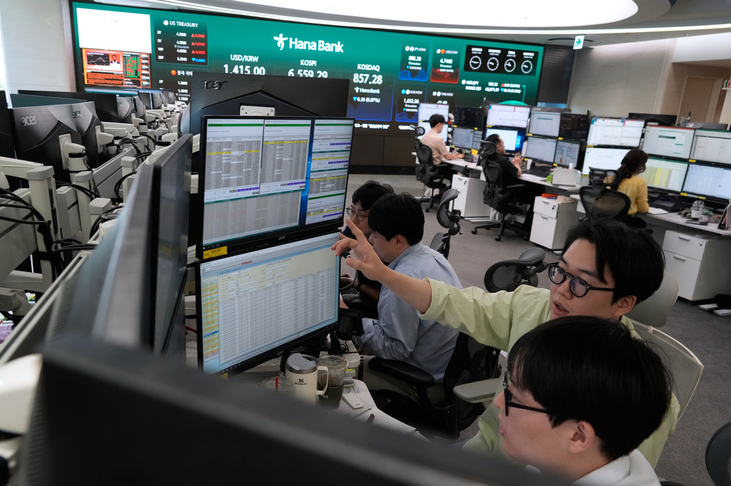 Currency traders work at the foreign exchange dealing room of the Hana Bank headquarters in Seoul, South Korea, Wednesday, Aug. 12, 2026. (AP Photo/Ahn Young-joon)