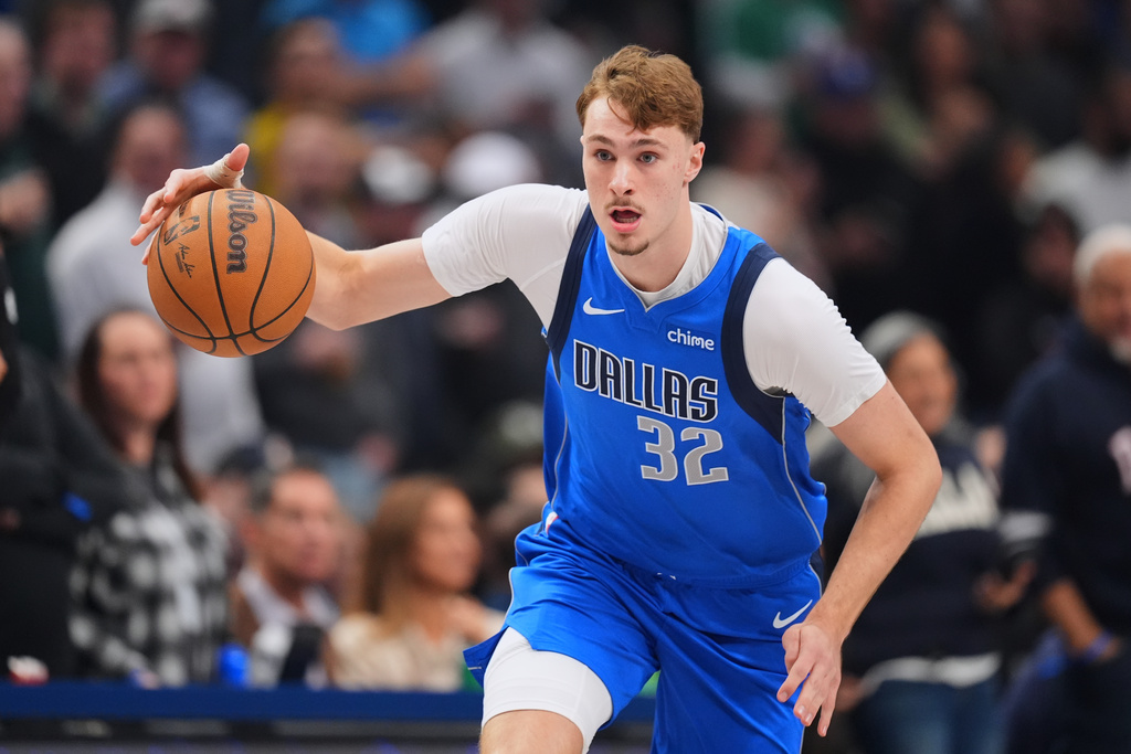 Dallas Mavericks forward Cooper Flagg dribbles the ball up court against the Miami Heat during the first half of an NBA basketball game Wednesday, Dec. 3, 2025, in Dallas. (AP Photo/Julio Cortez)