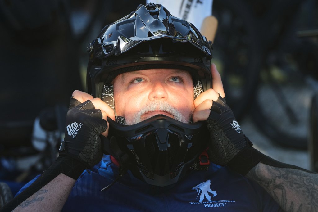 U.S. Marine Corps veteran Matthew Hannon adjusts his helmet before riding in the annual Florida Keys Soldier Ride organized by the Wounded Warrior Project, Friday, Jan. 9, 2026, in Key Largo, Fla. (AP Photo/Lynne Sladky)