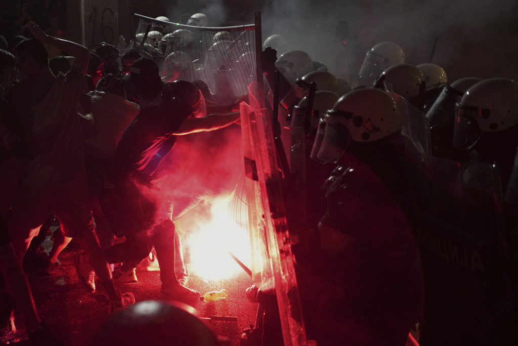 Anti-government protesters clash with riot police during a protest against increasing police brutality in the northern Serbian city of Novi Sad, Friday, Sept. 5, 2025. (AP Photo/Darko Vojinovic)