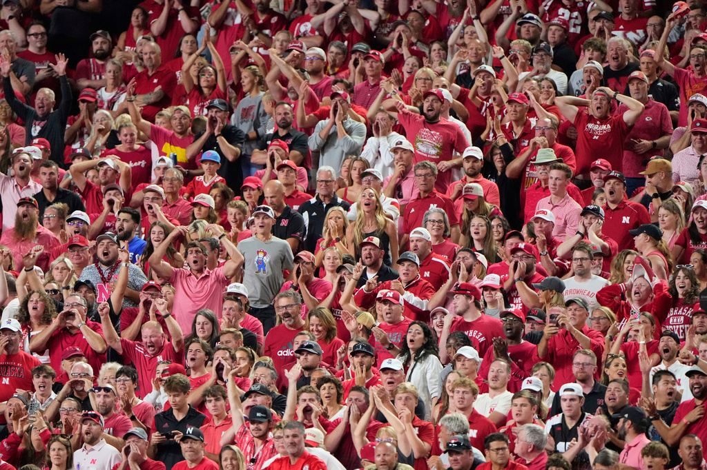 FILE - Fans cheer during the second half of an NCAA college football game between Cincinnati and Nebraska, Aug. 28, 2025, at Arrowhead Stadium in Kansas City, Mo. (AP Photo/Charlie Riedel, File)