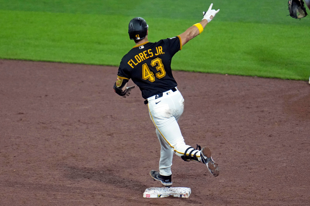 Pittsburgh Pirates' Rafael Flores Jr. celebrates as he rounds second base after hitting a solo home run off Milwaukee Brewers' Logan Henderson during the sixth inning of a baseball game in Pittsburgh, Wednesday, Sept. 16, 2026. (AP Photo/Gene J. Puskar)