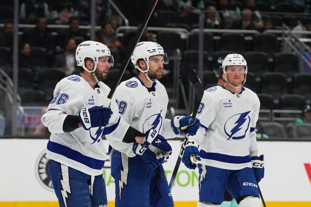Tampa Bay Lightning right wing Nikita Kucherov, left, celebrates his goal with left wing Brandon Hageld, center, during the second period of an NHL hockey game against the Seattle Kraken, Tuesday, March 17, 2026, in Seattle. (AP Photo/Lindsey Wasson)