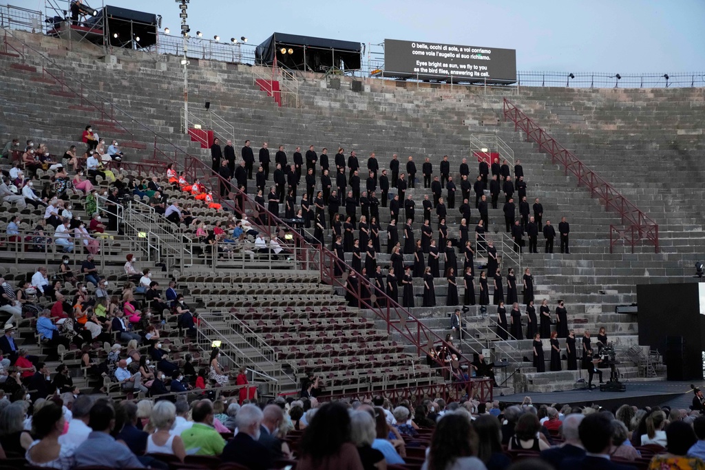 FILE - A view of the Chorus during 'Cavalleria Rusticana' lyric opera, at the Arena di Verona theatre, in Verona, Italy, Friday, June 25, 2021. (AP Photo/Luca Bruno, File)