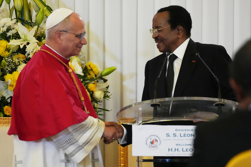 Pope Leo XIV shakes hands with Cameroon's President Paul Biya during the meeting with the authorities, civil society and the diplomatic corps in Yaounde Cameroon, Wednesday, April 15, 2026. (AP Photo/Andrew Medichini)