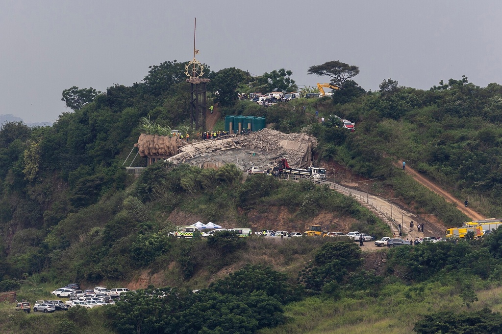 A concrete and debris following multi-story building that was under construction collapsed on a temple below it, near the town of Verulam, north of the east coast city of Durban, South Africa, Friday, Dec. 12, 2025. (AP Photo)