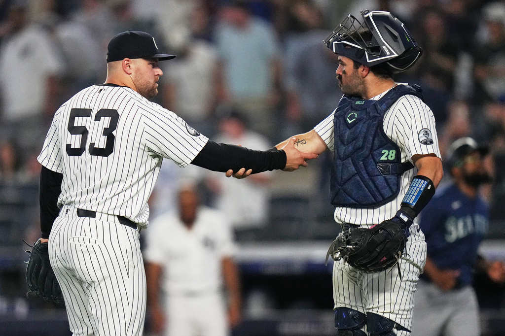 New York Yankees pitcher David Bednar (53) celebrates with catcher Austin Wells after a baseball game against the Seattle Mariners Tuesday, Aug. 11, 2026, in New York. (AP Photo/Frank Franklin II)