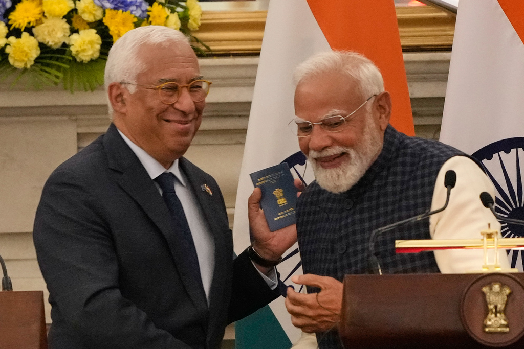 European Council President Antonio Costa, left, shows his Overseas Citizen of India (OCI) card to Indian Prime Minister Narendra Modi, during his press statement after reaching free trade agreement between India and EU in New Delhi, India, Tuesday, Jan. 27, 2026. (AP Photo/Manish Swarup)