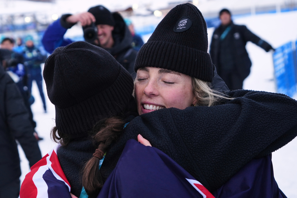 Silver medalist New Zealand's Zoi Sadowski-Synnott hugs a team member ater the women's snowboarding slopestyle finals at the 2026 Winter Olympics, in Livigno, Italy, Wednesday, Feb. 18, 2026. (AP Photo/Lindsey Wasson)