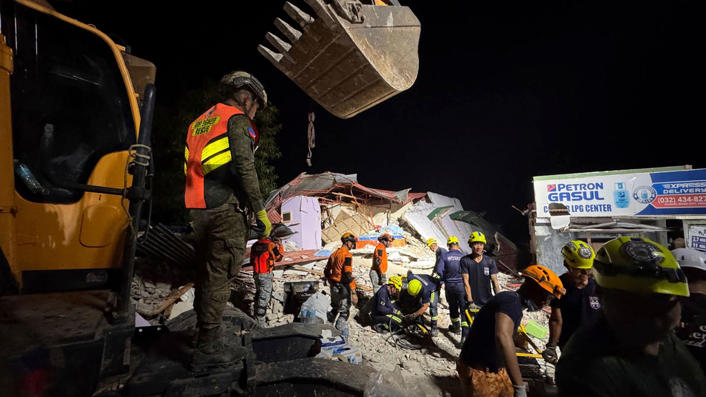 Rescuers search for survivors underneath rubble in Bogo city, Philippines, Wednesday, Oct. 1, 2025. (AP Photo/Aaron Favila)