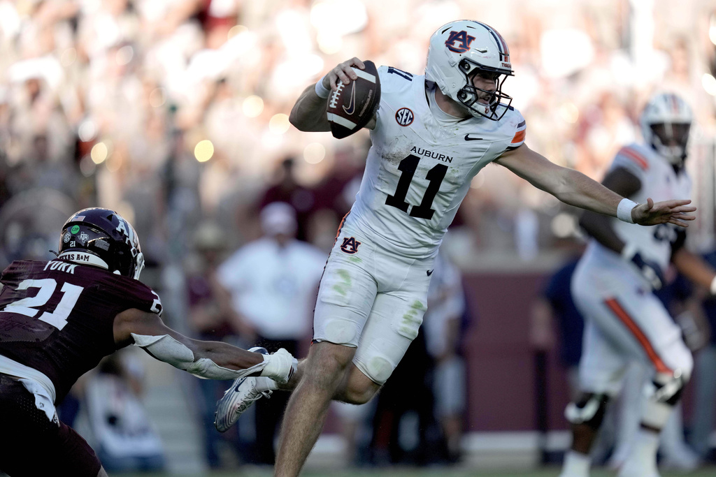 Texas A&amp;M linebacker Taurean York (21) holds on to the foot of Auburn quarterback Jackson Arnold (11) for a sack during the fourth quarter of an NCAA college football game Saturday, Sept. 27, 2025, in College Station, Texas. (AP Photo/Sam Craft)