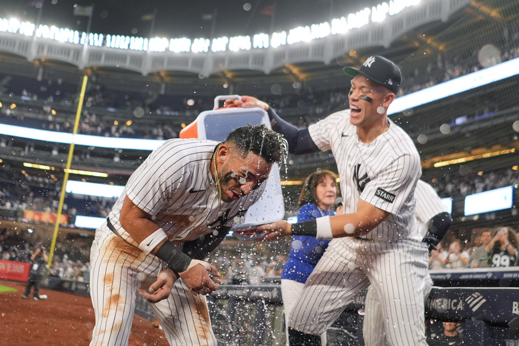 New York Yankees' Aaron Judge, right, celebrates with José Caballero after Caballero had a walk-off two run hit during the ninth inning of a baseball game against the Los Angeles Angels Wednesday, April 15, 2026, in New York. (AP Photo/Frank Franklin II)