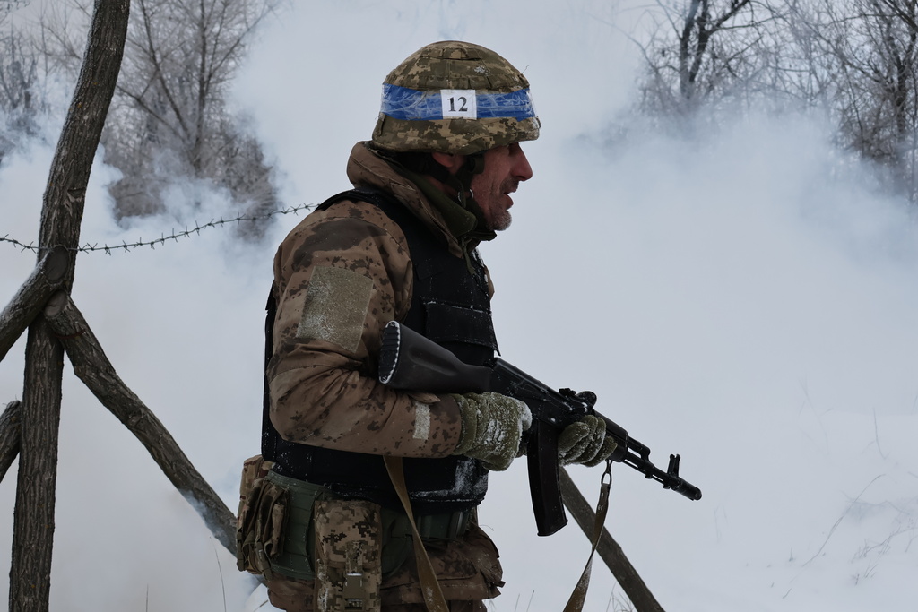 In this photo provided by Ukraine's 65th Mechanized Brigade press service, recruits perform drills at a training ground in the Zaporizhzhia region, Ukraine, Thursday, Jan. 1, 2026. (Andriy Andriyenko/Ukraine's 65th Mechanized Brigade via AP)