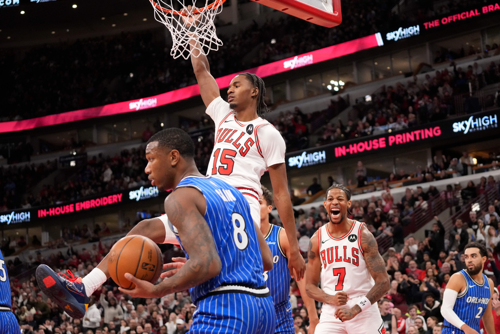 Chicago Bulls forward Julian Phillips (15) dunks the ball over Orlando Magic forward Jamal Cain (8) during the second half of an NBA basketball game, Friday, Jan. 2, 2026, in Chicago. (AP Photo/David Banks)