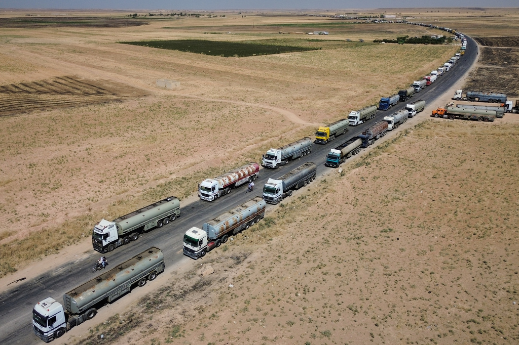 Oil tankers from the Rmeilan oil fields are backed up along a road after being stopped by local residents during ongoing protests against higher fuel prices near Tal Tamr in northeastern Syria, Wednesday, Sept. 16, 2026. (AP Photo/Baderkhan Ahmad)