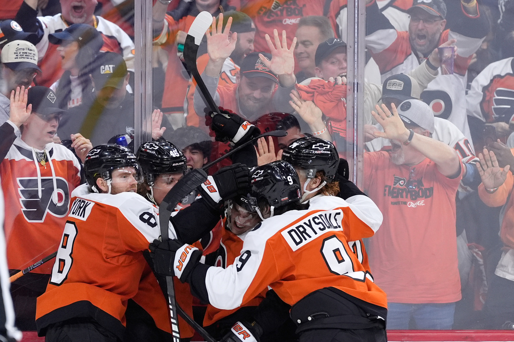Philadelphia Flyers' Denver Barkey, center, celebrates with teammates after scoring during the second period of Game 4 against the Pittsburgh Penguins in the first round of the NHL Stanley Cup hockey playoff series Saturday, April 25, 2026, in Philadelphia. (AP Photo/Matt Slocum)