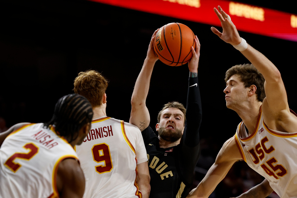 Purdue guard Braden Smith, second from right, looks to pass the ball while being guarded by Southern California guard Ryan Cornish (9) and center Gabe Dynes (45) during the second half of an NCAA college basketball game Saturday, Jan. 17, 2026, in Los Angeles. (AP Photo/Caroline Brehman)
