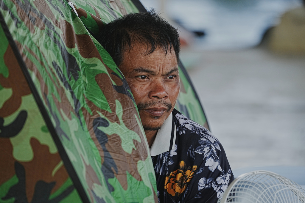A man sits in a tent as he takes refuge in Banteay Menchey provincial town, Cambodia, Saturday, Dec. 13, 2025, after fleeing home following fighting between Thailand and Cambodia. (AP Photo/Heng Sinith)