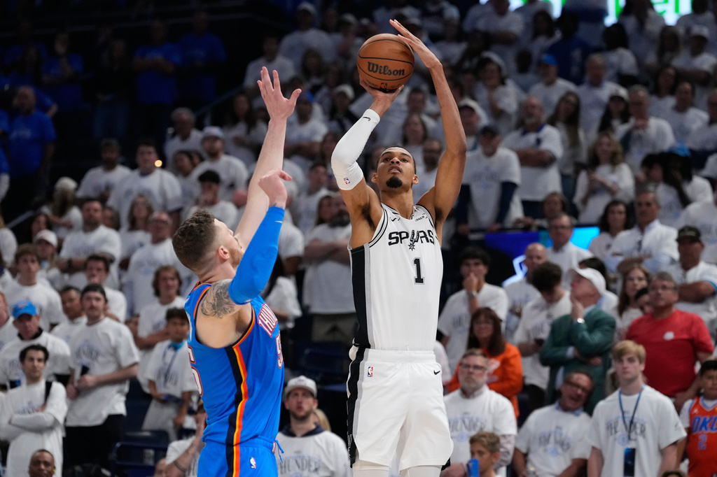 San Antonio Spurs forward Victor Wembanyama (1) shoots against Oklahoma City Thunder center Isaiah Hartenstein (55) during the second half of Game 2 in the Western Conference finals NBA basketball playoffs series Wednesday, May 20, 2026, in Oklahoma City. (AP Photo/Tony Gutierrez)
