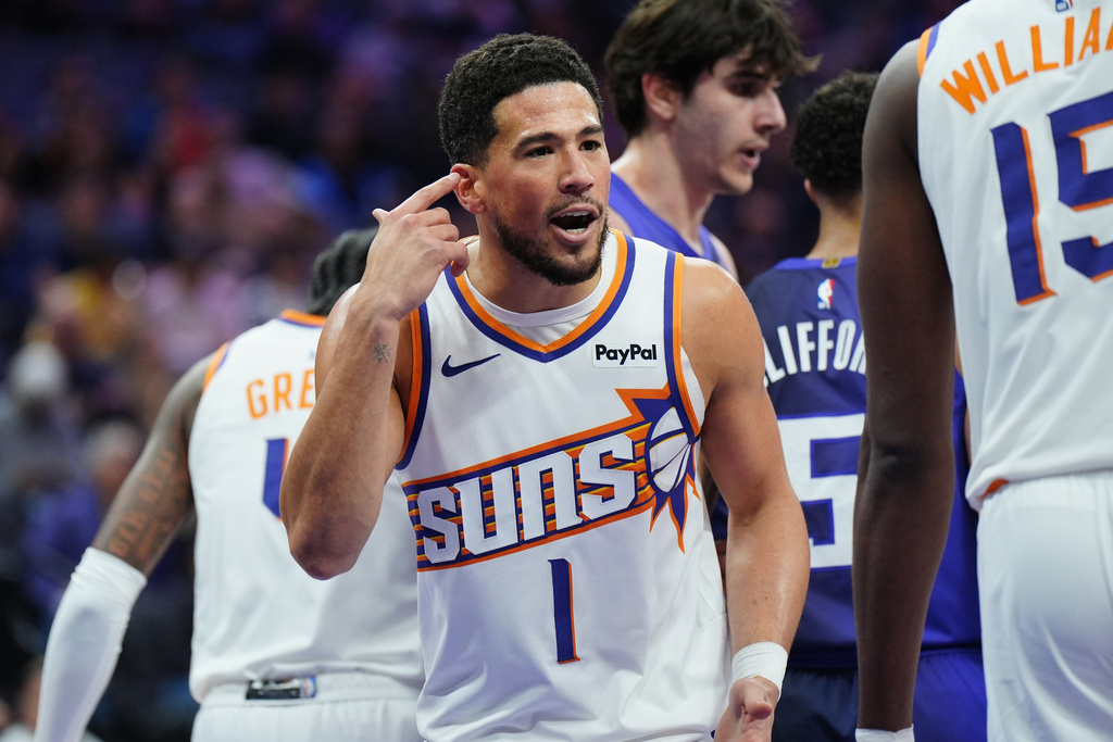Phoenix Suns guard Devin Booker (1) talks with an official during the first half of an NBA basketball game against Sacramento Kings, Tuesday, March 3, 2026, in Sacramento, Calif. (AP Photo/Alan Greth)