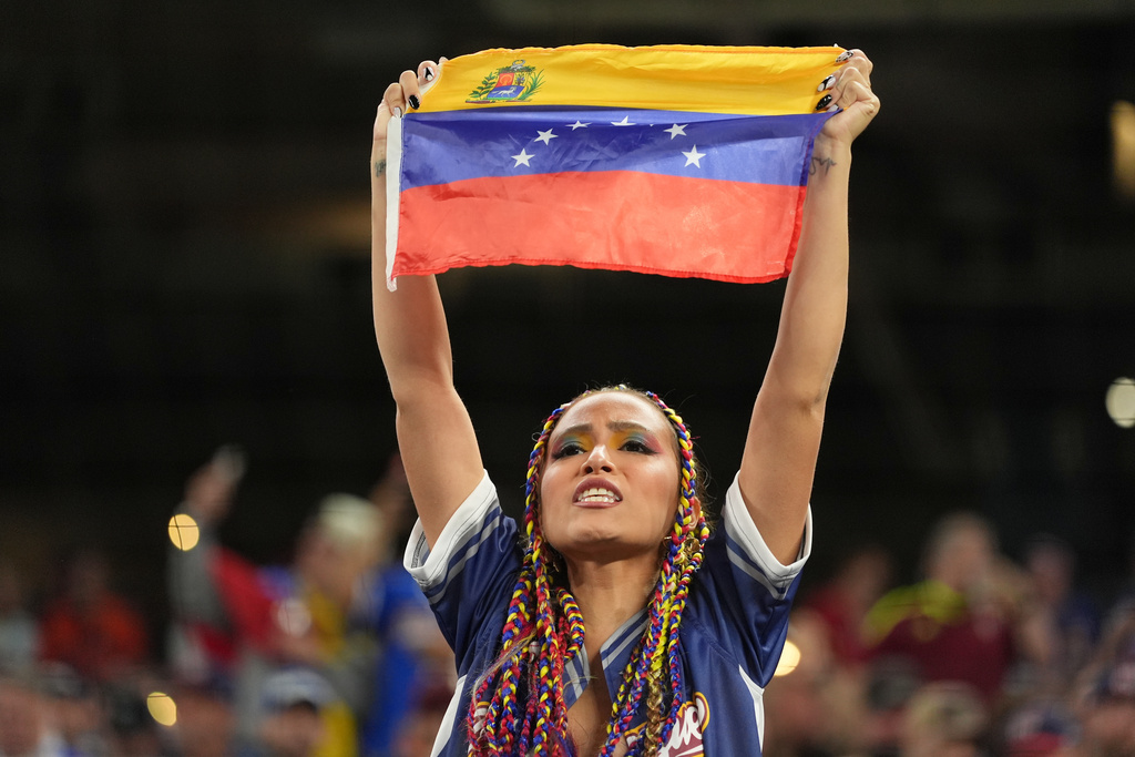 A Venezuela fan cheers the team before the championship game of the World Baseball Classic against the United States, Tuesday, March 17, 2026, in Miami. (AP Photo/Rebecca Blackwell)