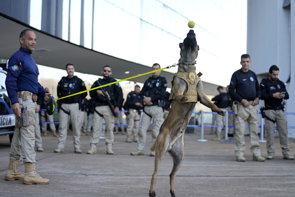 Police with a police dog stand guard outside the Supreme Court during the verdict and sentencing phase of a trial for those charged in an alleged coup plot to keep Brazil's former President Jair Bolsonaro in office after his 2022 election defeat, in Brasilia, Brazil, Tuesday, Sept. 9, 2025. (AP Photo/Eraldo Peres)