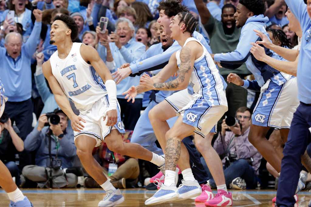 North Carolina guard Seth Trimble (7) celebrates with teammates and fans after he hit a 3-point basket in the closing seconds for the go-ahead goal during the second half of an NCAA college basketball game against Duke, Saturday, Feb. 7, 2026, in Chapel Hill, N.C. (AP Photo/Chris Seward)