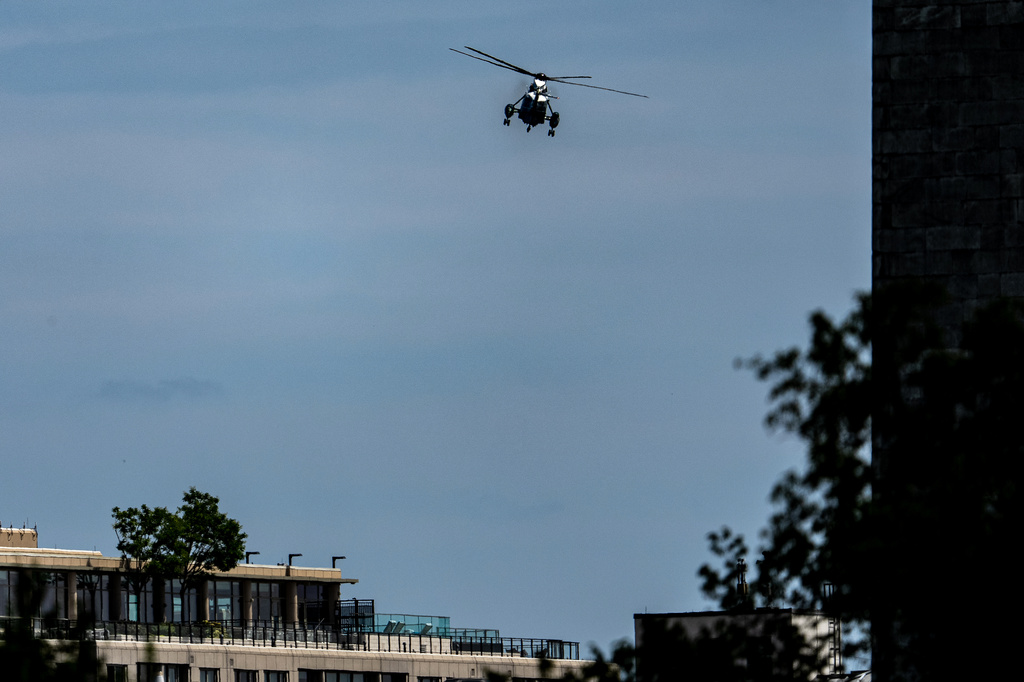 Marine One, with President Donald Trump aboard, flies past the Washington Monument after lifting off from the Ellipse, Tuesday, Aug. 4, 2026, in Washington. (AP Photo/Alex Brandon)